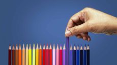 person picking out colored pencil