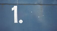 A number one with a period painted on a wall for name order on income tax return story