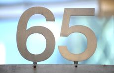 the number 65 in grey metallic against a light blue background